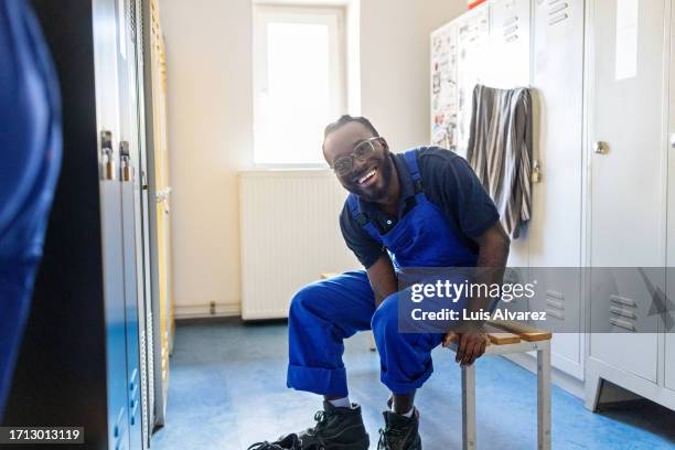 train engineer changing in railway workshop locker room - train driver stock pictures, royalty-free photos & images