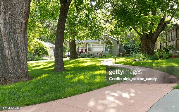cute cottage at end of winding pathway - woodland house stock pictures, royalty-free photos & images