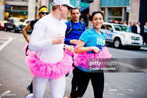 cross dressed men and woman running in new york - gay pride parade stock pictures, royalty-free photos & images