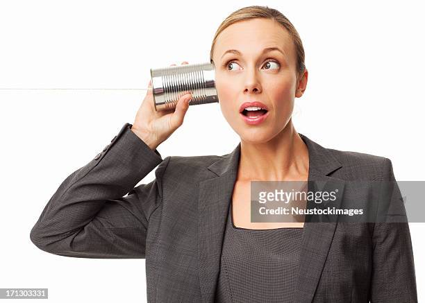 businesswoman listening to a string phone - isolated - listening tin can stock pictures, royalty-free photos & images