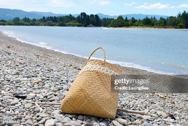 flax kete on beach - basket stock pictures, royalty-free photos & images