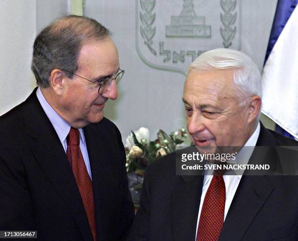 Israeli Prime Minister Ariel Sharon speaks to George Mitchell, the former US senator and Northern Ireland peace mediator who heads a US-led...