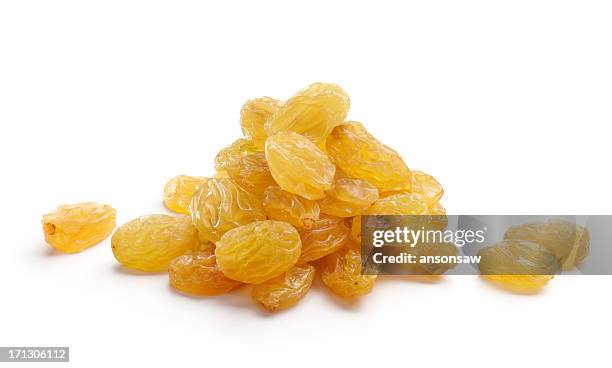 bunch of golden yellow raisins isolated on white background - rozijn stockfoto's en -beelden