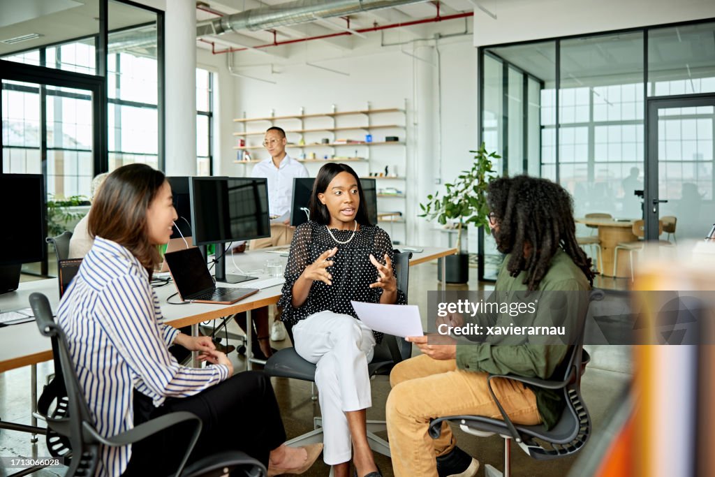 Three creative colleagues exchanging ideas