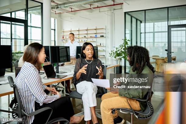 three creative colleagues exchanging ideas - director office stock pictures, royalty-free photos & images