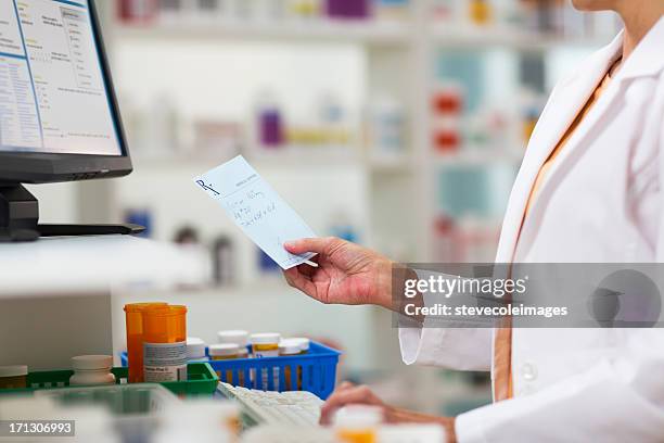 pharmacists fulfilling prescription - prescription medicine stock pictures, royalty-free photos & images