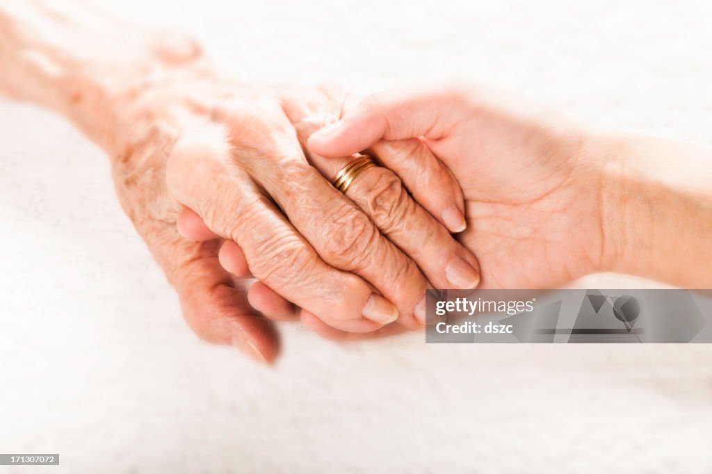 Old and young holding hands