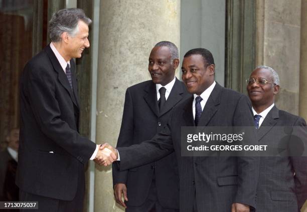 Ivorian Prime Minister Pascal Affi Nguessan shakes hands16 February 2001 with French Presidency Secretary General Dominique de Villepin as Ivorian...