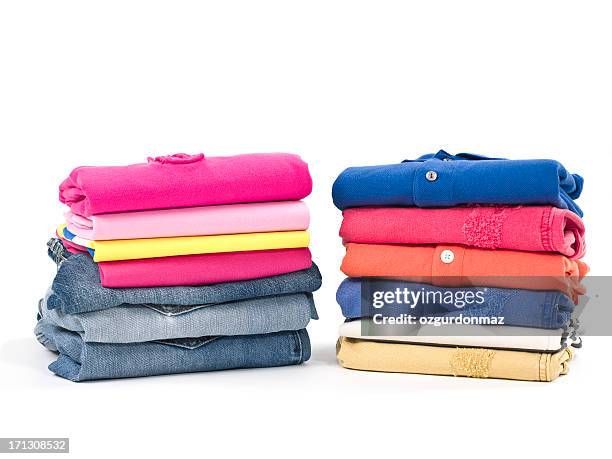 casual clothes folded in pile on white - folded clothes stock pictures, royalty-free photos & images