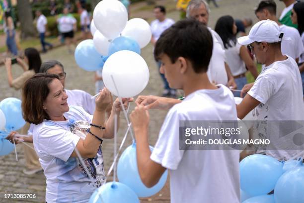 People attach sticks to balloons during an anti-abortion rally organized by PL Mulher group at Praca da Liberdade square in Belo Horizonte, state of...