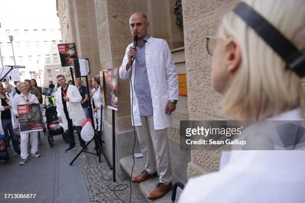 Striking medical physicians gather in front of a building of the German Federal Health Ministry after marching to protest against working conditions...