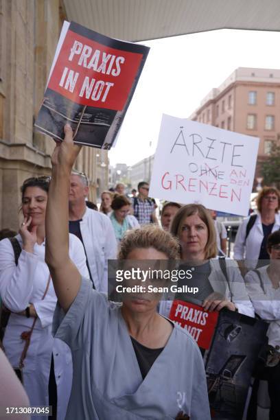 Striking medical physicians gather in front of a building of the German Federal Health Ministry after marching to protest against working conditions...