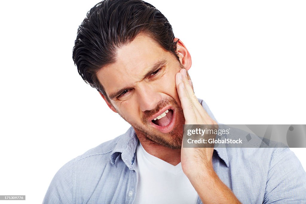 Man with painful expression holding one cheek