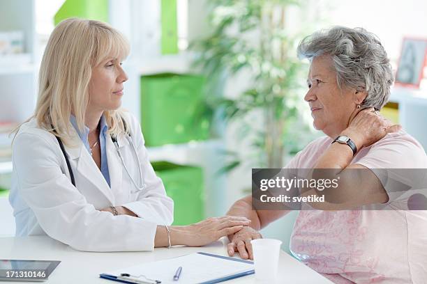 senior woman at doctor's office - person with a neck pain stock pictures, royalty-free photos & images