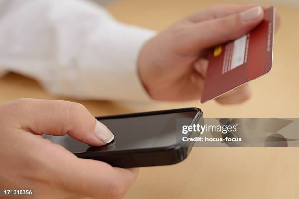 buying with smart phone - corporate crime stock pictures, royalty-free photos & images