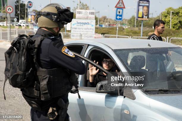 Police officers check suspects at a check point, searching for Hamas militants from Gaza strip on October 8, 2023 in Ashdod, Israel. On Saturday, the...