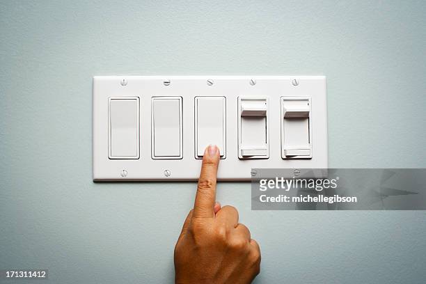 woman's hand und biegen sie an der ampel - electrical switch stock-fotos und bilder