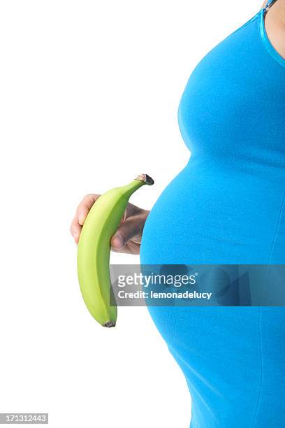 pregnant woman holding banana - 5 months fetus stock pictures, royalty-free photos & images