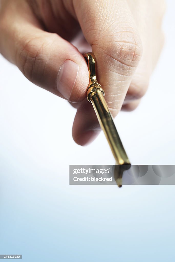 Close-up of Hand Holding a Golden Skeleton Key