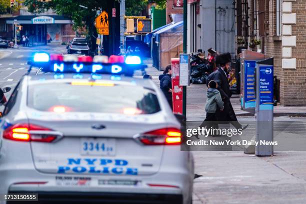 October 7: NYPD officers keep an eye on orthodox Jewish worshippers on Flushing Avenue in Williamsburg, Saturday, Oct. 7, 2023.