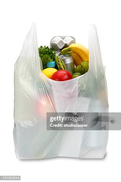 a white plastic grocery bag filled with produce - plastic bag stock pictures, royalty-free photos & images