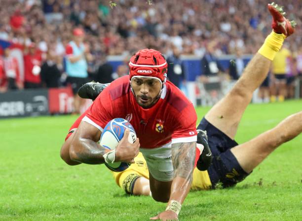 Tonga's inside centre Pita Ahki dives across the line to score a try during the France 2023 Rugby World Cup Pool B match between Tonga and Romania at...