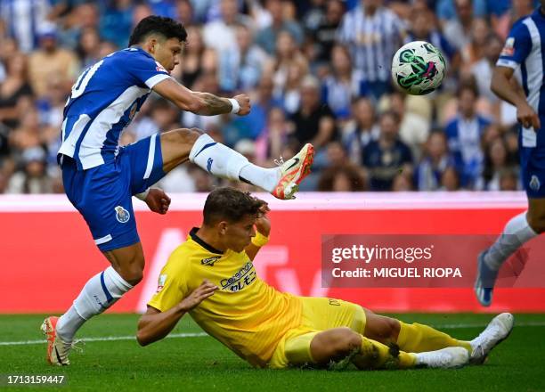 Porto's Brazilian forward Evanilson Barbosa scores his team's first goal past Portimonense's Portuguese defender Filipe Relvas during the Portuguese...