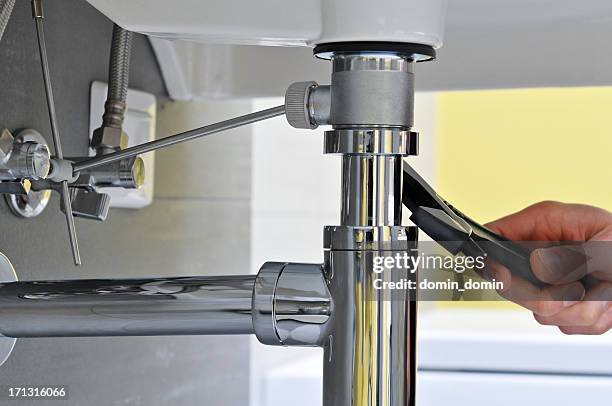 gros plan de main en réparation de plombier travaillant sur l'évier - faucet stock photos et images de collection