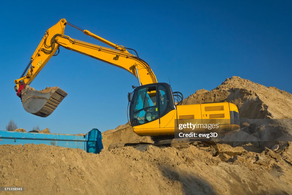 Excavator working at the top of ground