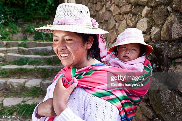 bolivian woman carrying her baby, isla del sol, bolivia - bolivia daily life stock pictures, royalty-free photos & images