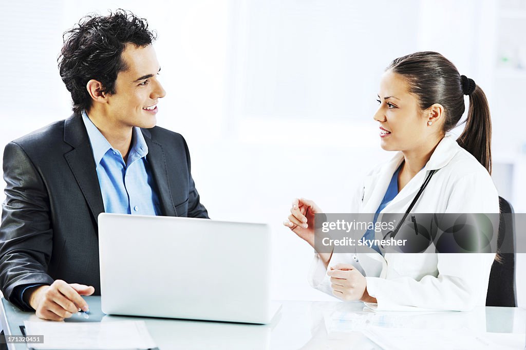 Administrator talking with a female doctor.