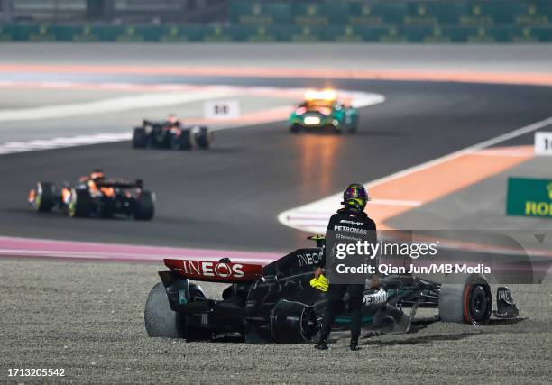 Lewis Hamilton of Great Britain stands by the Mercedes AMG Petronas F1 Team F1W14 after colliding with team-mate George Russell during the F1 Grand...