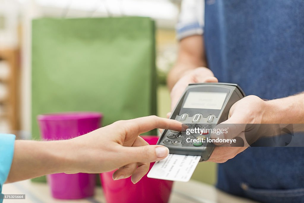 Female Entering PIN Number In Credit Card Reader