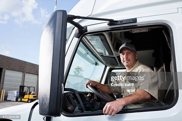 truck driver sitting in cab of semi-truck - mid adult men stock pictures, royalty-free photos & images