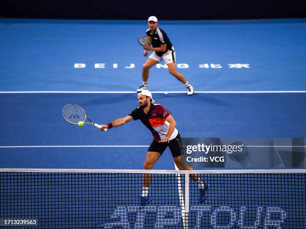 Hugo Nys of Monaco and Jan Zielinski of Poland return a shot in the Men's Doubles Quarter-final match against Wesley Koolhof of Netherlands and Neal...