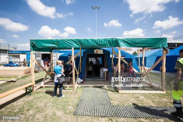 red cross tent on refugee camp, italian eartquake of 2012 - red cross hospital stock pictures, royalty-free photos & images