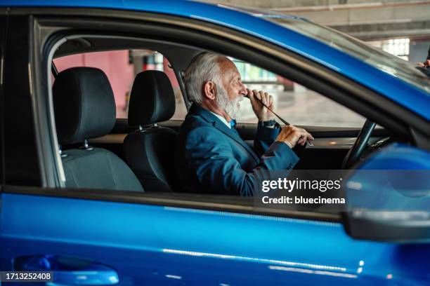 senior businessman fastening his seat belt - grey belt stock pictures, royalty-free photos & images