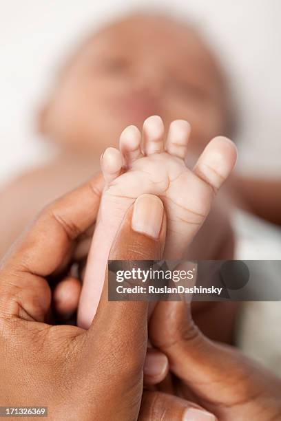 baby foot massage. - barefoot soles female stock pictures, royalty-free photos & images