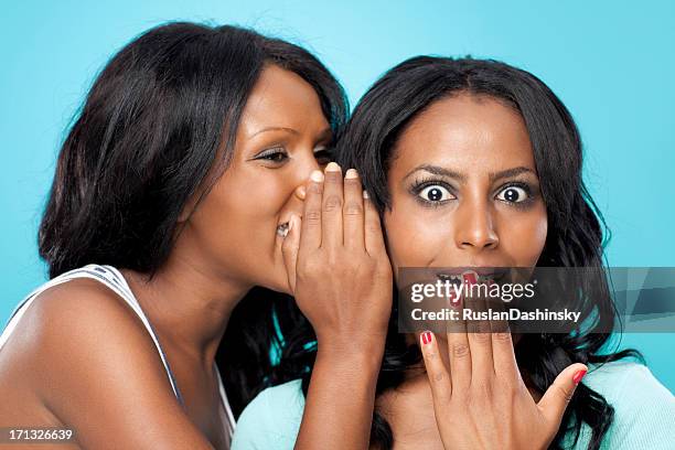 sharing secrets. - whispering stock pictures, royalty-free photos & images