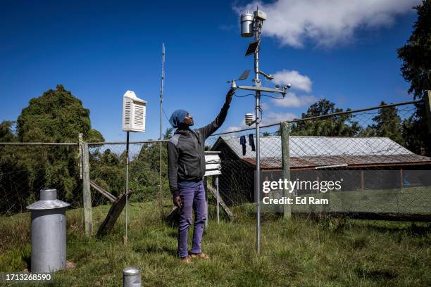Charles Mwangi, weather station operator checks a weather monitoring device at the Meteorological Station on Mount Kenya on September 29, 2023 in...