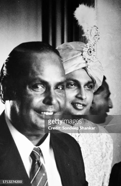 Anil Ambani, the younger son of Indian business tycoon Dhirubhai Ambani, poses for a photograph with his father after he is dressed for his wedding...