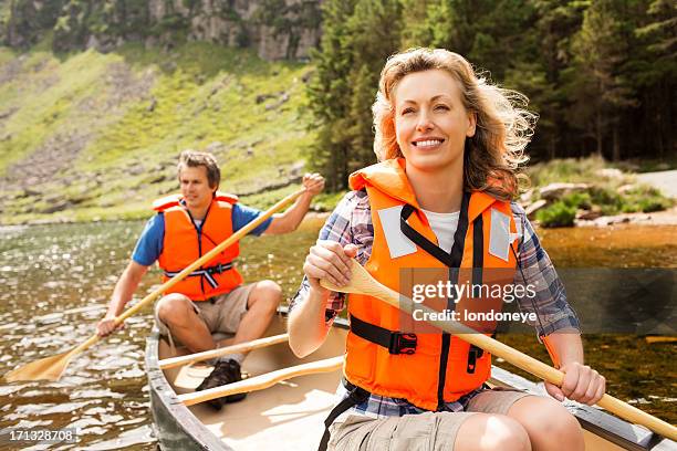 couple on canoe trip - canoe stock pictures, royalty-free photos & images