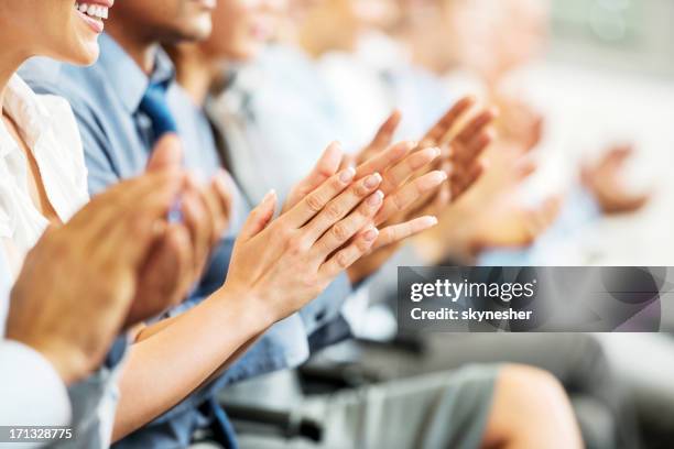 gruppe der geschäftsleute sitzen in einer linie applaudieren. - african american speaking to an audience stock-fotos und bilder