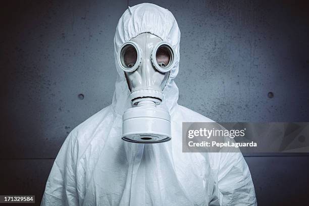 danger: radioactive attack - white jumpsuit stock pictures, royalty-free photos & images