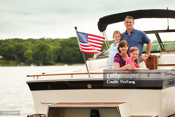 happy, smiling american family boating on midwest lake with motorboat - motorboot varen stockfoto's en -beelden