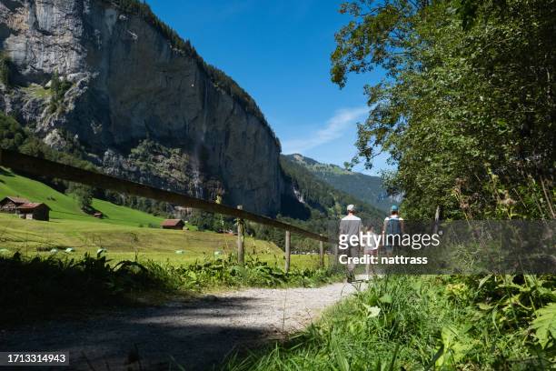 family exploring a beautiful town while on vacation in europe - staubbach falls stock pictures, royalty-free photos & images