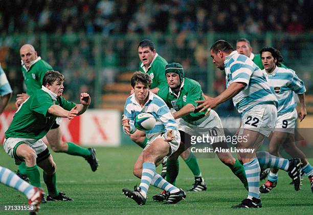 Eduardo Simone of Argentina passes to teammate Martin Scelzo during a Rugby World Cup quarter-final play-off match against Ireland at Twickenham,...