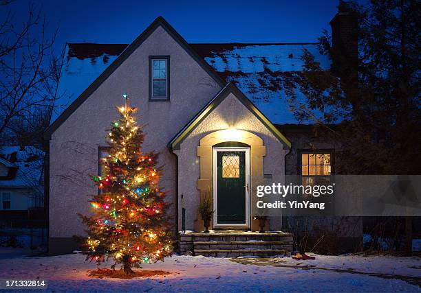 outdoor christmas tree decorated with lights in front of home - christmas tree home stock pictures, royalty-free photos & images