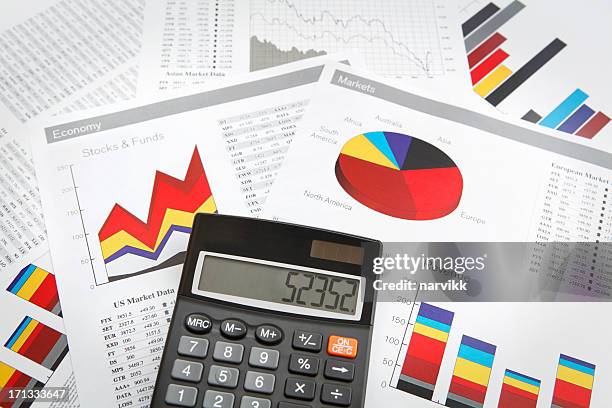 charts printed on paper and calculator - generic market stock pictures, royalty-free photos & images