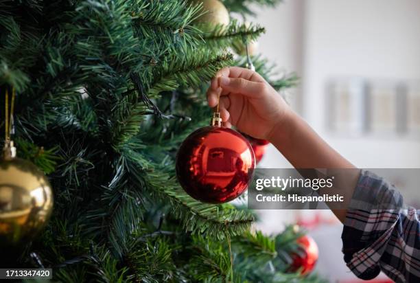 boy decorating the christmas tree - christmas tree detail stock pictures, royalty-free photos & images